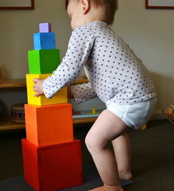 ребенок строит башню 